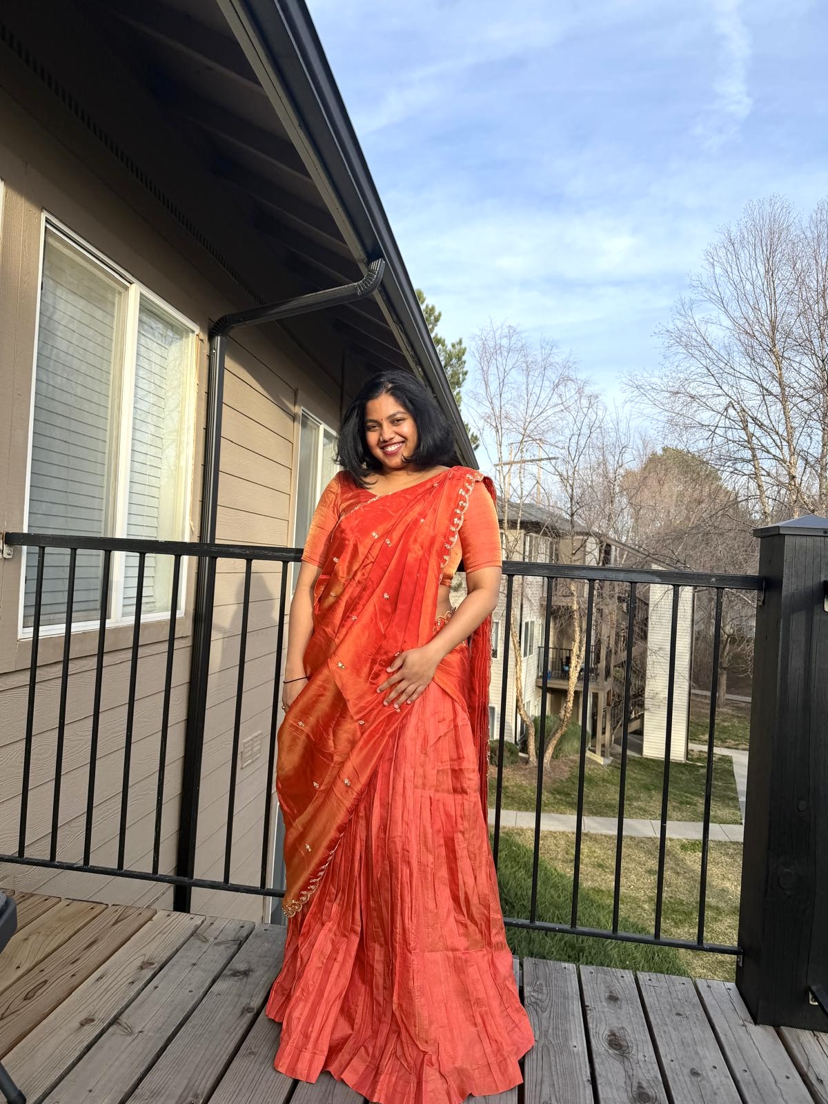 Kruthi wearing her first custom orange outfit